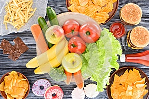 top view of assorted junk food and fresh fruits with vegetables on wooden
